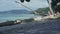 Seychelles. Praslin Island. Cute slim woman reading the book lying on the thick tree trunk at the water on the beach