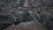 Seychelles. Praslin Island. Three barefoot tourists going up, climbing the stones close-up. People exploring the island