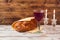 Shabbat concept with wine glass and challah bread on wooden table