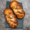 Shabbat Shalom - challah bread on grey background. Top view