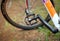 Shabby bicycle pedal on a blurred background of the wheel and grass