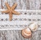 Shabby chic background with seashells and lace on old wood