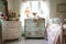 shabby chic bedroom with cheery floral prints, and vintage dresser