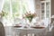 shabby chic dining room, with table decorated with fresh blooms and simple white dishes