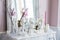 Shabby chic home design. Beautiful decoration table with a candles, flowers in front of a mirror