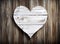 Shabby chic white heart on dark wooden texture background