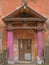 A shabby entrance with pink columns