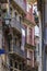 Shabby facades of Portuguese houses and balconies with metal railings in the narrow streets of old town Porto, Portugal