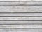 Shabby gray wooden planks of outdoor pavement