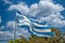Shabby greek flag waving in the wind
