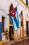 Shabby house in Old Havana with a cuban flag