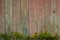 Shabby old fence of red-brown color, with moss and nails, background of wooden boards, in the style of rustic, grunge,