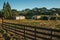 Shabby shacks from a ranch with wooden fence