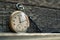 Shabby vintage swiss pocket watch on the wooden boards