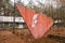 Shabby white silhouette of Lenin on a red triangle monument background