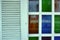 Shabby White Stained Glass Window Shutters Blue Green Orange Purple Background