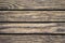 Shabby wood planks closeup. Rough lumber surface. Warm brown wooden background for vintage card.