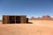 Shack in the desert with mesa and butte in the background