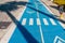 Shade from palm trees on the bike path. bicycle path. bike path with pedestrian crossing sign in the shade of palm trees