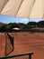 Shade umbrella on clay tennis court
