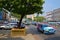 Shade under a big tree with vehicles on Sule Pagoda Road in Yangon, Myanmar