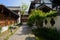 Shaded alleyway between tile-roofed buildings in sunny summer mo