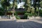 Shaded flagstone paved yard before ancient building in woods