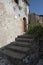 A shaded, old, stone-clad concrete staircase in a Sicilian village