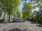 The shaded pavements of an Aberdeen City Tree lined street, with cars parked outside Residents Houses on a Summers Morning.
