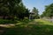 Shaded roadside lawn in city of sunny summer morning