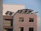 Shades of Brown painted apartment buildings blocks with solar panels mounted at the roof top