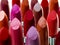 Shades for the individual. Closeup of a variety of lipstick colours.