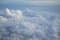 Shades of light blue color sky and constantly change floating white cloudscape view from airplane window