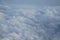 Shades of light blue color sky and floating white cloud wonderland view from airplane window