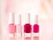 Shades of pink and red nail polish set on glamour background, nailpolish bottles for manicure and pedicure, luxury