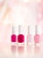 Shades of pink and red nail polish set on glamour background, nailpolish bottles for manicure and pedicure, luxury