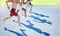 Shadow of athletes running and racing together on a sports track. Closeup of active and fit runners sprinting or jogging