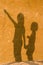 Shadow of children on the wall of sand