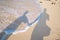 Shadow couple holding hands and Abstract sand of beach and soft wave background