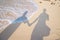 Shadow couple holding hands and Abstract sand of beach and soft wave background