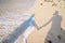 Shadow couple holding hands and Abstract sand of beach and soft wave background