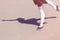 Shadow of dancer girl which makes dance moves in a bathing suit for dancing and ballet shoes