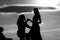 Shadow figures of man and woman holding hands. Love and relations. Silhouettes of love couple man and woman at rock