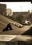 Shadow of an individual sitting under a highway overpass