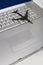 Shadow of jumbo jet over apple macintosh keyboard