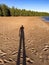 Shadow of lonely lost man on empty beach