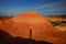 The shadow of a man walking among the ancient open deposits of multi-colored clays Kiin Kerish in Kazakhstan