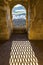 Shadow of metal window grid on a floor of the room