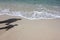 Shadow of a mother and daughter on the beach.