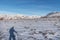 Shadow of a mountaineer reflected in the snow in the Sierra Nevada, with the Mulhacen and Veleta peaks in the background